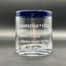 A clear glass mug with a blue rim, featuring the definition of momma rita' in white text.