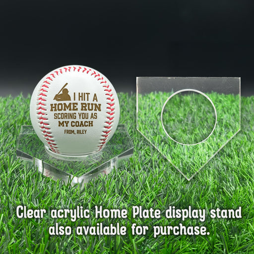 A personalized baseball with red stitching is placed on a clear acrylic stand, accompanied by a text overlay that reads Clear acrylic Home Plate display stand also available for purchase.