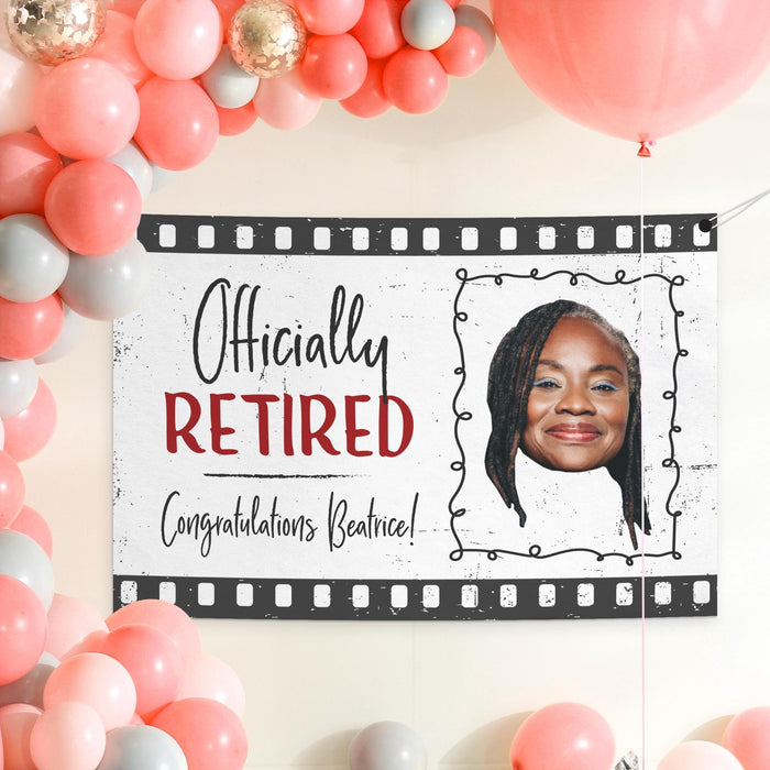 Personalized retirement banner displayed as a party backdrop surrounded by festive balloons. Custom retirement decoration designed for retirement celebrations and farewell parties.