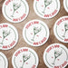 Multiple round dirty martini coasters spread across a tabletop, each featuring the personalized bar name, olive martini illustration, and established year.