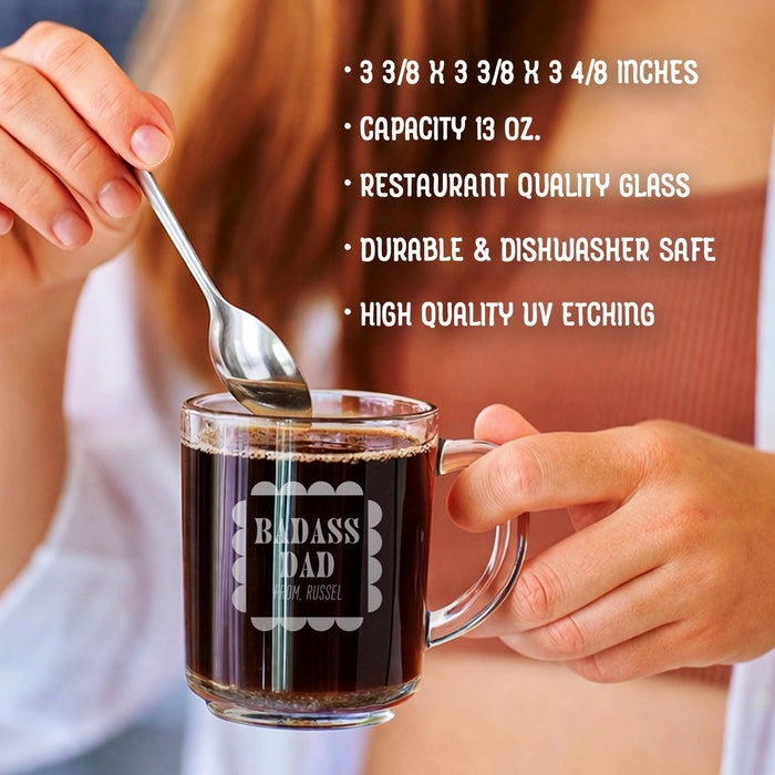 A person is holding a glass mug with a message engraved on it. The image is accompanied by a text overlay that reads • 3 3/8 x 3 3/8 x 3 4/8 inches • Capacity 13 oz. • restaurant quality glass • durable & dishwasher safe • high quality uv etching