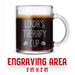 A glass mug with an engraved design on it. The mug is filled with tea, and there is text under the mug that reads "Engraving Area is 2 in x 2 in”