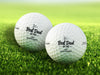 two white titleist golf balls with customizable personalized black Best Dad By Par designs on top of golf course grass
