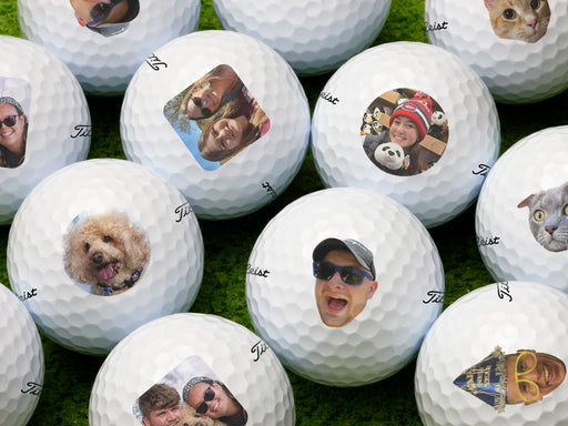 multiple titleist golf balls with different photos on them on top of golf course grass