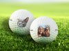 two white titleist golf balls with photos on them on golf course grass