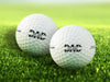 two white titleist golf balls with custom personalized established dad designs ontop of grass background 