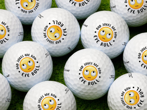 multiple white titleist golf balls with dad jokes are how eye roll emoji designs on top of green grass 