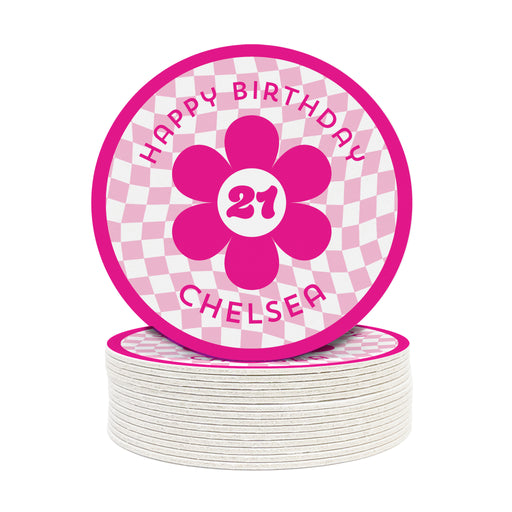 A single coaster is shown on top of a stack of coasters against a white background. Coasters are designed with hot and light pink ink. Coaster text reads Happy Birthday Chelsea with the number 21 in the center of a pink flower.