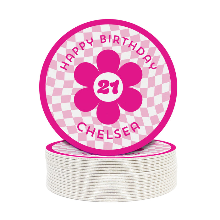 A single coaster is shown on top of a stack of coasters against a white background. Coasters are designed with hot and light pink ink. Coaster text reads Happy Birthday Chelsea with the number 21 in the center of a pink flower.