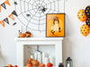 single frame with halloween retro vintage art of ghost cat stealing bucket of candy with an only take one sign, sitting on top of a white fireplace surrounded by halloween decor such as pumpkins, balloons, spider webs, and banners