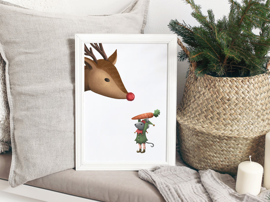 white frame on grey couch with a christmas print of an elf mouse offering a carrot to a reindeer surrounded by grey pillows, candles, and a pine plant in a straw basket