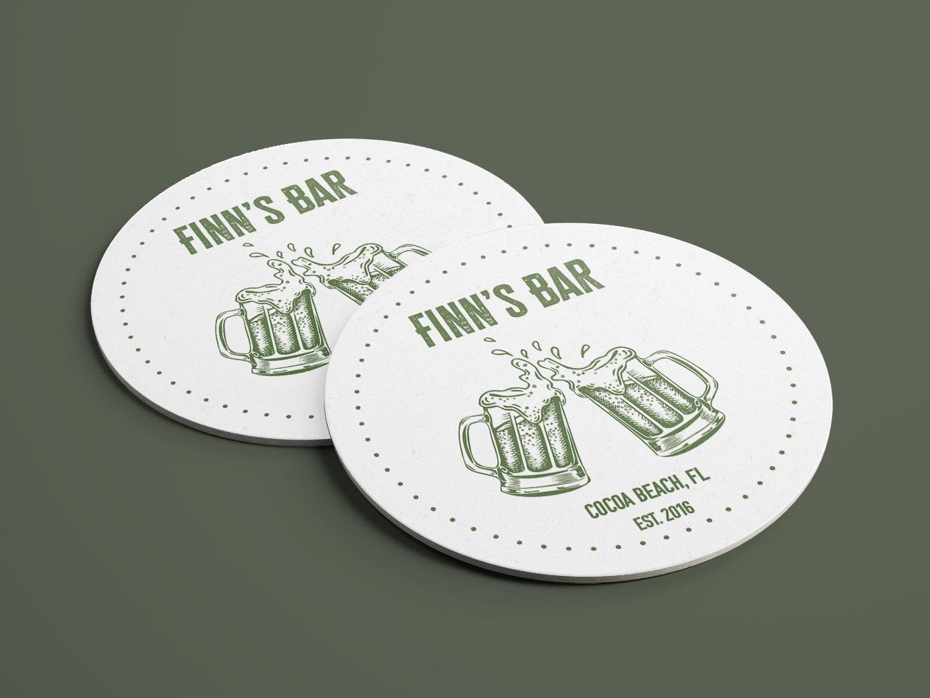 a white coaster with two mugs of beer on top of it