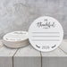 A stack of white paper coasters with the text "I'm Thankful for" and "2026" printed on them, placed on a white wooden surface.