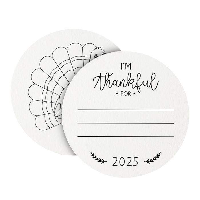Front and back of coasters shown on a white background. Front of coasters show the text I'm thankful for, has lines for writing in a response, and current year. Back of round coasters feature a turkey illustration.