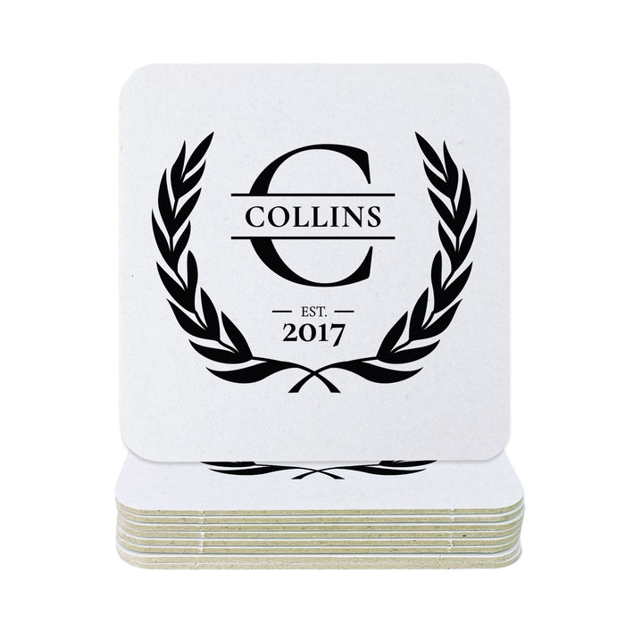 A stack of square white coasters with rounded corners, featuring a black printed monogram design with the word 'COLLINS' inside a laurel wreath and 'EST. 2017' below, shown on a plain white background.