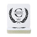A stack of square white coasters with rounded corners, featuring a black printed monogram design with the word 'COLLINS' inside a laurel wreath and 'EST. 2017' below, shown on a plain white background.