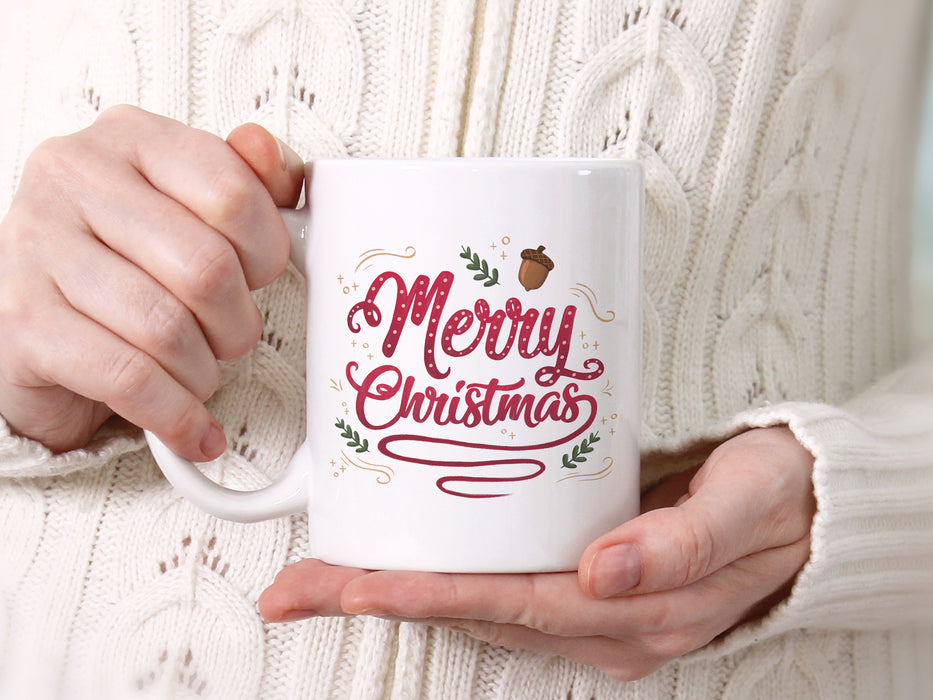 white mug with merry christmas typography artwork being held by a woman in a white knit winter sweater