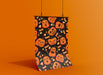 orange background with single poster of halloween retro vintage art of a pumpkin pattern with jack o lanterns with different faces and candy candy corn pattern