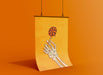 orange background with single poster of halloween retro vintage art of skeleton hand holding a lollipop against yellow background