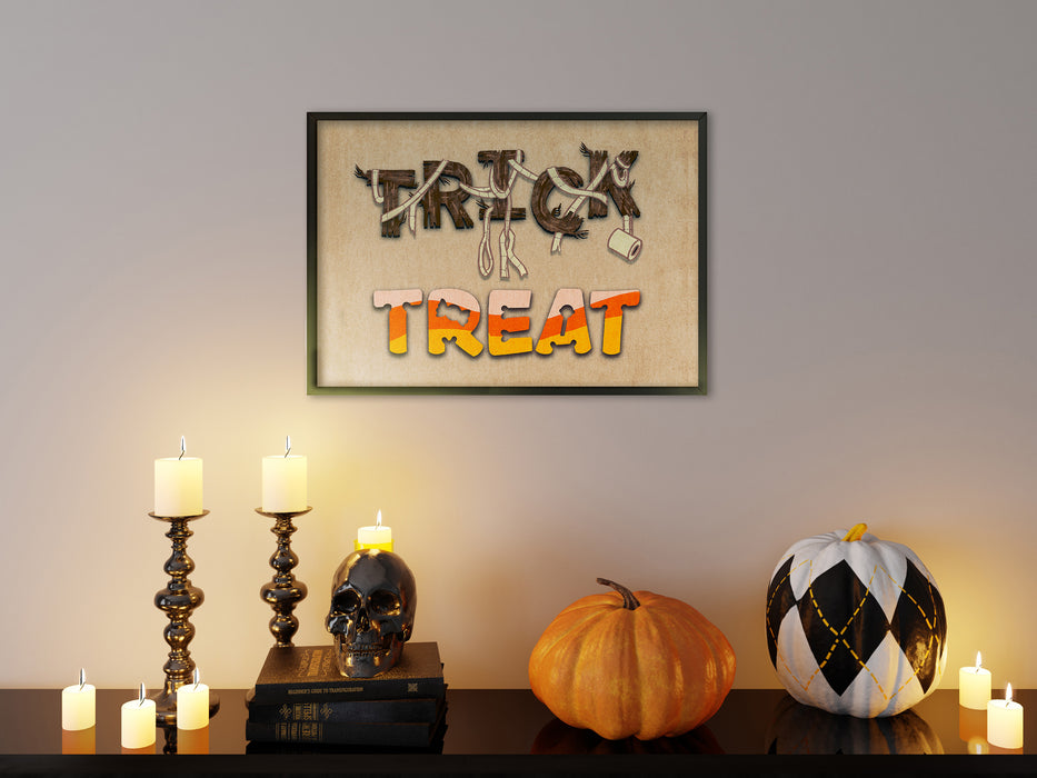 single frame on dark white wall with halloween art of trick or treat typography over a wooden countertop surrounded by halloween decoration such as pumpkins, candles, and a skull ontop of books