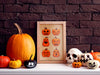 single framed halloween print of pumpkin faces against a brown brick wall surrounded by pumpkins, jack o lanterns, and a skeleton head