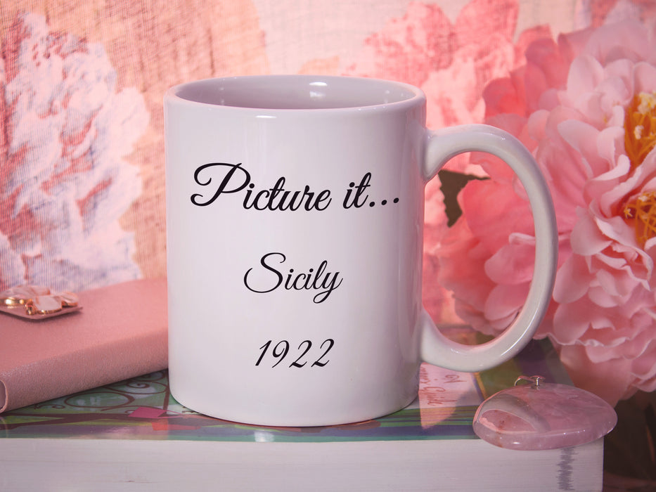 white mug with golden girls inspired typography design with quote that says Picture it...Sicily 1922 in pink room surrounded by flowers, a wallet and sitting ontop of a book