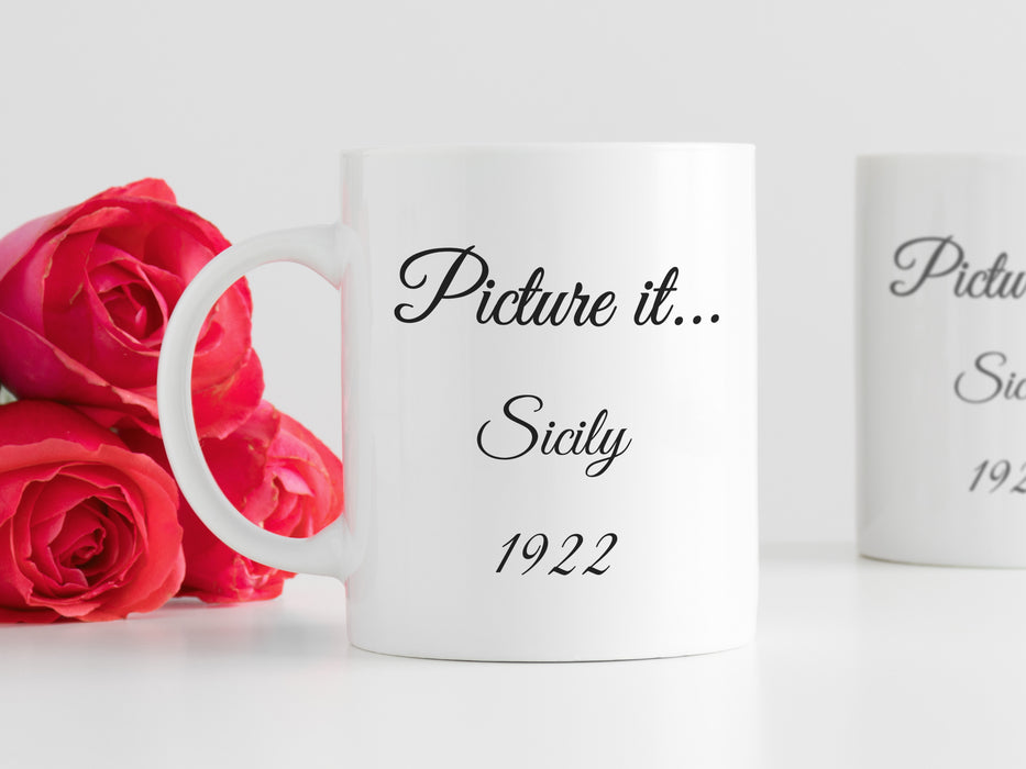 white mug on white table that has golden girls inspired typography design with quote that says Picture it...Sicily 1922 next to red roses and a white mug in the background