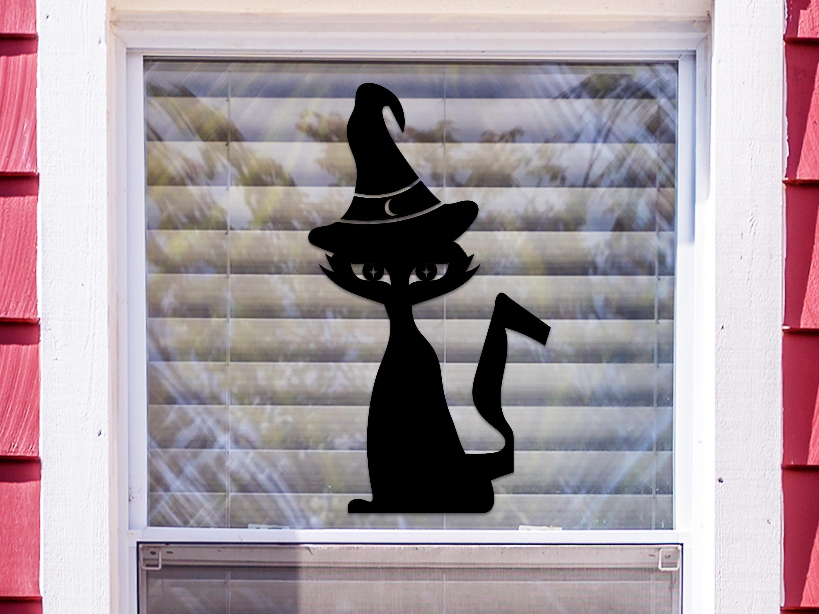 Witch Cat sticker (in orange) is shown stuck to the exterior of a window.