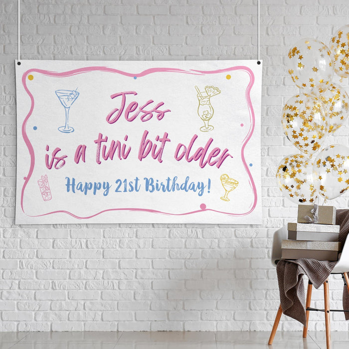 "Tini Bit Older" birthday banner displayed as wall décor featuring a custom name and birthday age.
