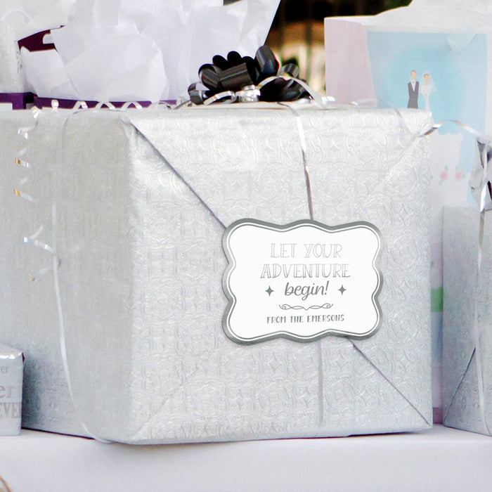 Silver wrapped gifts decorated with personalized “Let Your Adventure Begin” wedding gift tags. Styled as elegant packaging inspiration for weddings, bridal showers, and engagement celebrations.