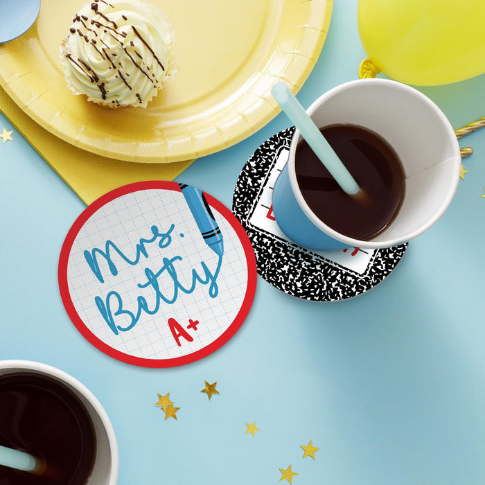 Teacher coasters displayed on a desk with drinks and decor. Demonstrates how the coasters look in everyday use.