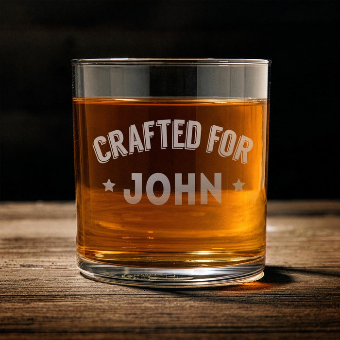 Front-facing product image of the whiskey glass on a wooden table with the “Crafted For John” design fully visible. This simple presentation helps customers clearly see the personalization layout and engraving style.