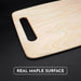 Maple cutting board with handle showing the natural wood grain and real maple surface.