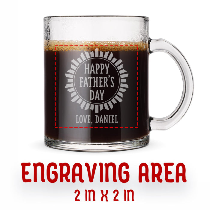 A glass mug with an engraved design on it. The mug is filled with tea, and there is text under the mug that reads "Engraving Area is 2 in x 2 in”