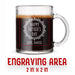 A glass mug with an engraved design on it. The mug is filled with tea, and there is text under the mug that reads "Engraving Area is 2 in x 2 in”