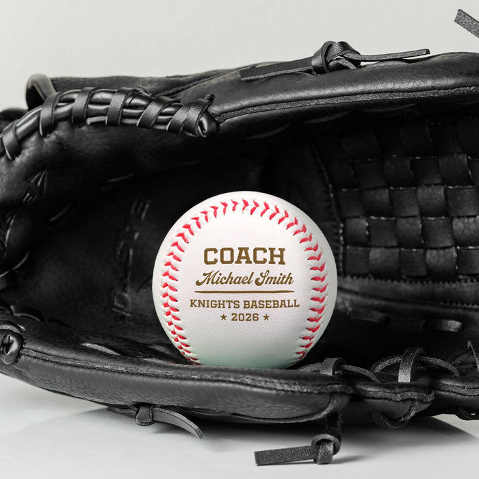 A black baseball glove with a personalized baseball resting on top of it. The baseball design features Coach Michael Smith Knights Baseball 2026