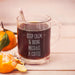 A glass mug filled with coffee, with the text "KEEP CALM & BRING MICHAEL A COFFEE" engraved on it.