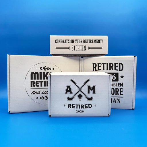 Retirement golf ball gift boxes displayed in multiple sizes with both generic and golf-themed designs. Personalized with names, retirement years, and custom messages.