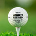 Personalized retirement golf ball featuring the "Retired And Loves It" design with a custom name. Displayed on a golf tee against a golf course background.
