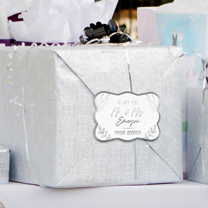 Silver gift bag decorated with a personalized “Mr. & Mrs.” wedding gift tag in metallic silver foil. Adds a modern and elegant finishing touch to wedding gift packaging.