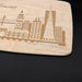 Close-up of the engraved San Francisco cityscape showing the bridge, skyline buildings, and natural maple wood grain.