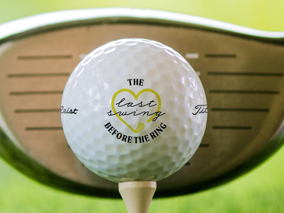 Titleist golf ball is shown sitting on a golf tee with a golf club behind it. Ball features custom printed Last Swing Before the Ring Design.