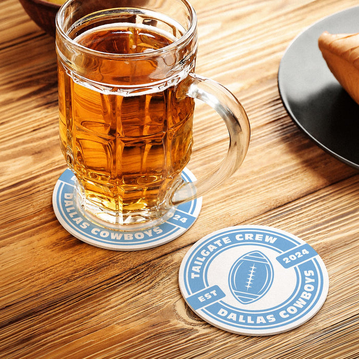Personalized paper coasters with football design displayed with a beer mug on a wooden table.