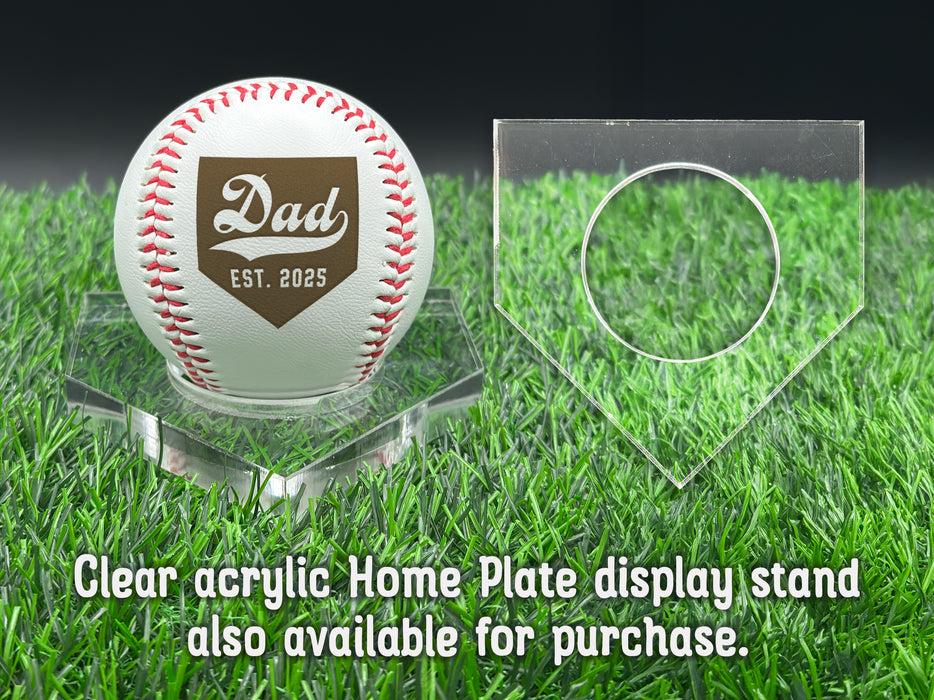 A personalized baseball with red stitching is placed on a clear acrylic stand, accompanied by a text overlay that reads Clear acrylic Home Plate display stand also available for purchase.