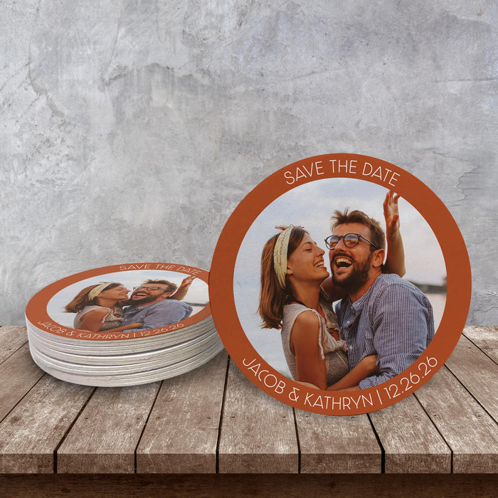 Custom photo Save the Date coaster displayed on a rustic wood surface. Personalized with a favorite photo, names, and wedding date.
