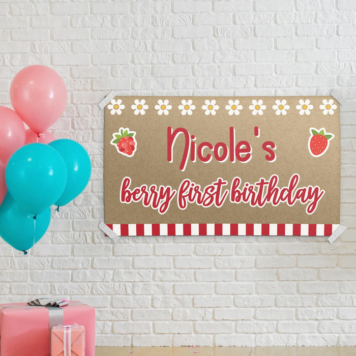 Berry first birthday banner displayed as party wall décor with colorful balloons and custom personalized name printed on butcher paper.