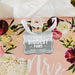 Floral wedding-themed display featuring a personalized “Your Biggest Fans” gift tag in metallic silver foil. Styled with soft flowers and romantic wedding décor accents.
