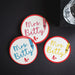 Multiple personalized A+ grade coasters arranged on a dark background. Showcases color variation and visual contrast.