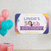 Retro birthday banner displayed as party décor with colorful balloons and celebration decorations.
