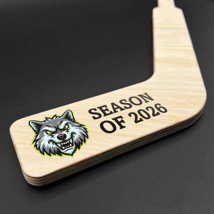 Close-up detail of the goalie stick blade highlighting vibrant full-color UV printed team logo and season text on natural wood grain.
